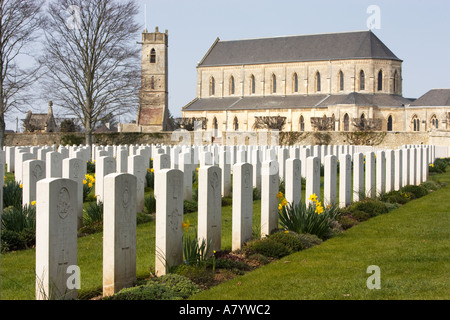 Kriegsgräber in Ranville Militärfriedhof, Normandie, Frankreich zeigt die Kirche hinter Stockfoto