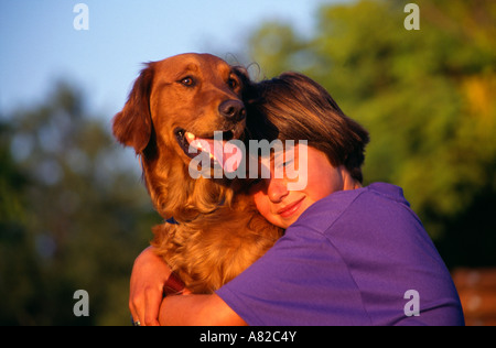 Junge Mädchen 8-10 Jahre alten umarmen Setterhund redhead rotem Fell Spätsommer nachmittag Vorderansicht close up US USA United States HERR © Myrleen Pearson Stockfoto