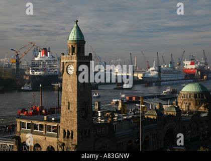 Historische Uhr Turm der Landungsbrücken Gebäude und Queen Mary II im Trockendock von Blohm + Voss in Hamburg, Deutschland Stockfoto