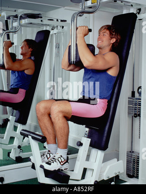 Junger Mann am Gymnasium Geräten trainieren. Stockfoto