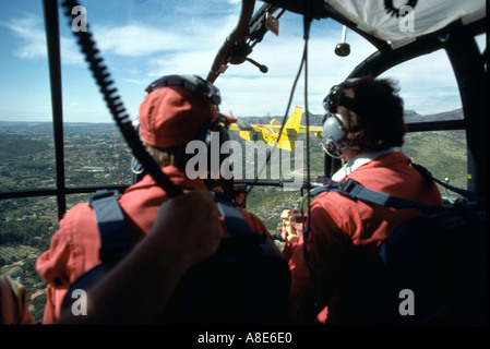 Piloten im Cockpit der Feuerwehrmänner Alouette III Hubschrauber Befehl Regie Canadair wasser Bomber in Richtung wildfire, Provence, Frankreich, Europa, Stockfoto