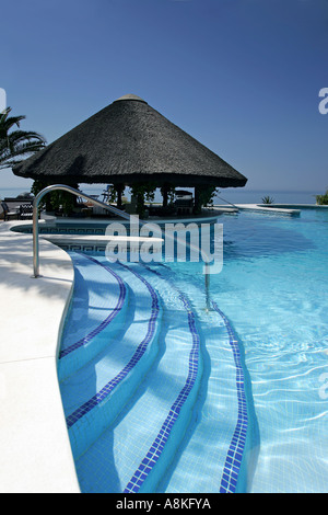 Tiki-Hütte und Bar Schritten von Schwimmbad des Luxushotels an einem sonnigen Tag in Spanien Stockfoto