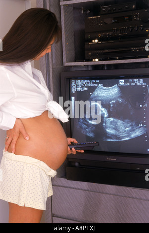 Schwangere Mutter stolz die Silhouette Fötus ihr 5 Monate altes Baby zu Hause auf Ultraschall video anzeigen Stockfoto