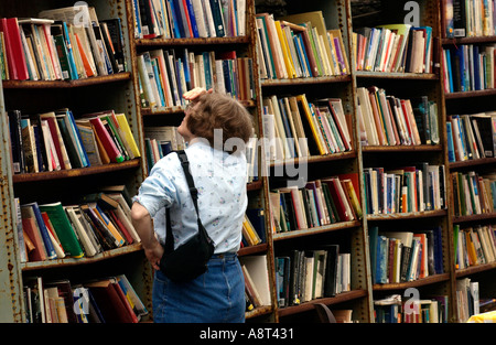 Frau durchsuchen die Ehrlichkeit Buchhandlung im Heu Schloss in ländlichen Markt Stadt von Hay on Wye Powys Wales UK Stockfoto