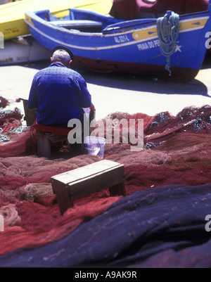 1999 HISTORISCHE, ÄLTERE FISCHER, DIE BEIM AUSBESSERN VON NETZEN SITZEN ALBUFEIRA ALGARVE PORTUGAL Stockfoto