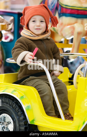 JUNGE BERGEWELT AUF KARNEVAL SWING RIDE PARK. Stockfoto