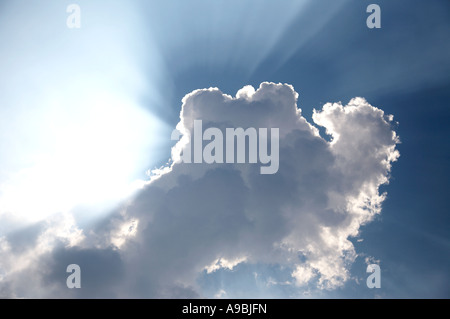 Sonnenstrahlen hinter Wolken platzen Stockfoto