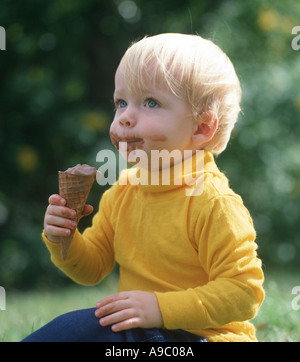 kleiner Junge mit Schokoladen-Eiscreme-Kegel Stockfoto