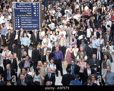 Traveller Chaos und Unterbrechungen in der Liverpool Street Bahnhof s-bahn Passagiere warten & oben Abfahrtstafeln für Informationen UK Stockfoto