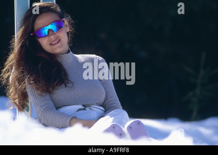 Frau liegt im Schnee, Neigung auf Skiern. Stockfoto