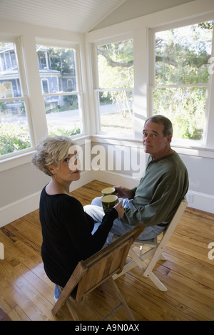 Porträt des reifes paar drinnen sitzen renoviertes Haus Stockfoto