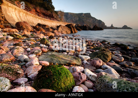 Schöne Dämmerung Licht bei ansteys in der Nähe von Torquay South Devon mit langen steinbruch Punkt im Hintergrund und einem ruhigen Meer Cove Stockfoto