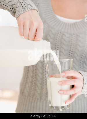 Frau Gießen Glas Milch Stockfoto