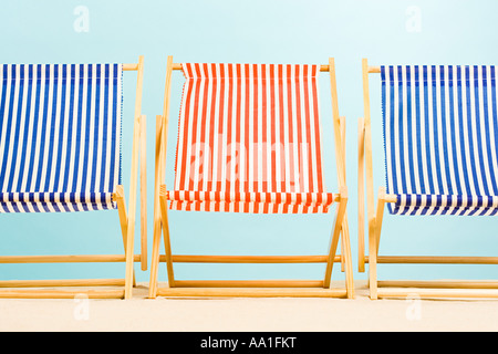 Sandstrand mit einer Gruppe von Liegestühlen und Sonnenschirmen ohne