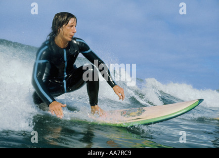 Wasser Schuss der Surfer auf einer Welle abnehmen, so wie er auf seinem Surfbrett Croyde Bay Devon England aufsteht hautnah Stockfoto