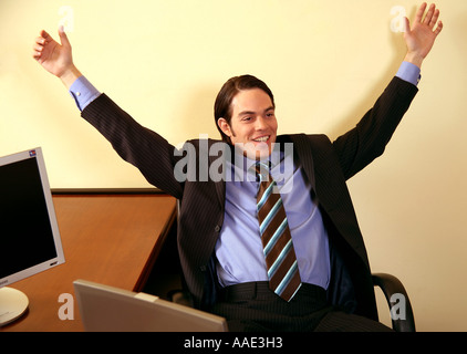 Junger Geschäftsmann lächelnd und Arme in Aufregung Stockfoto