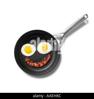 Smiley-Gesicht-Speck und Eiern in der Pfanne Stockfoto