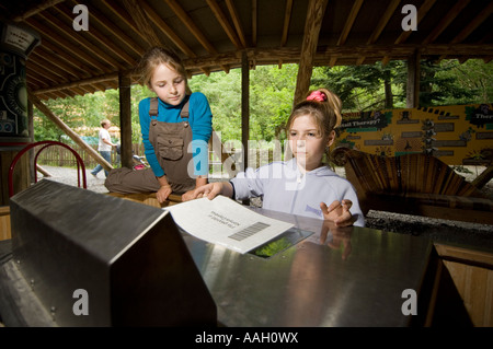 Kinder, die Scan-Informationen über die ökologischen Kosten der verschiedenen gängigen Lebensmitteln essen wir im Zentrum für Alternative Technologie Stockfoto