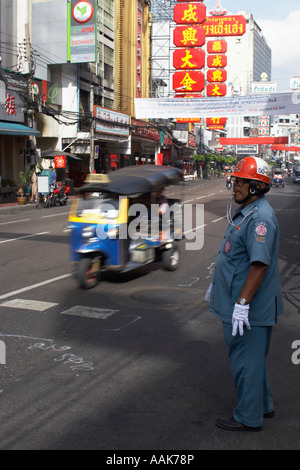 Verkehrspolizist mit Tuk-Tuk vorbei im Hintergrund Stockfoto