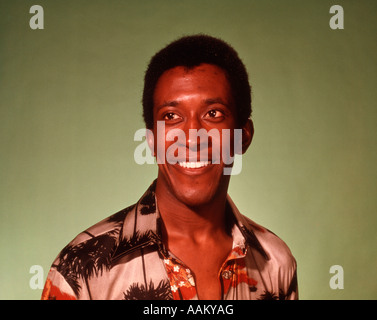 1970ER JAHRE PORTRAIT AFROAMERIKANISCHE MANN GRÜN HINTERGRUND Stockfoto
