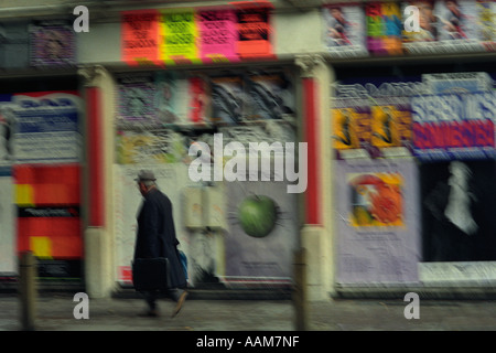 Mann mit Jacke und Hut zu Fuß in einem Londoner Vorort Straße Stockfoto