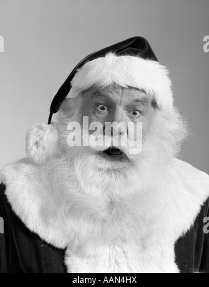 1960ER JAHREN SANTA CLAUS PORTRÄT BLICK IN DIE KAMERA ÜBERRASCHTE GESICHTSAUSDRUCK WEIßEN BART SCHNURRBART PELZ GETRIMMT ANZUG Stockfoto