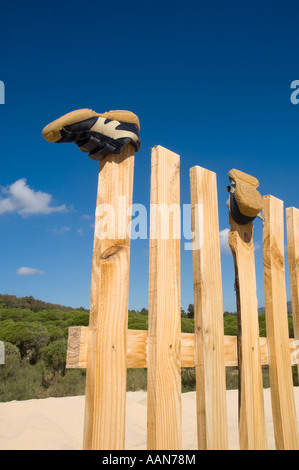 Schuhe auf einem Holzzaun Stockfoto