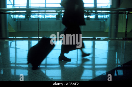 Passagier ziehen kleine Hand Gepäckkoffer Abfahrt lounge UAE Middle East in Dubai Airport Stockfoto