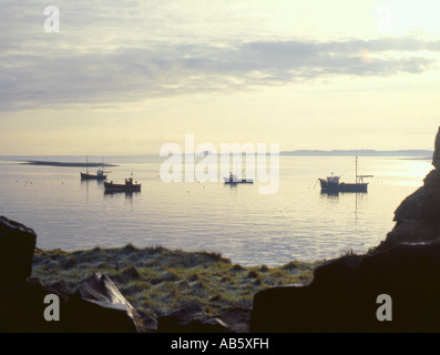 Angeln Boote aus heiligen Insel in den frühen 1980er Jahren, Northumberland, England, Blick Richtung Bamburgh Castle und der Küste von Northumberland Stockfoto