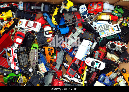 Eine Kiste voll mit kleinen Spielzeug-Autos zum Verkauf auf einem Flohmarkt. Stockfoto