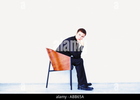 Mann auf Stuhl sitzend Stockfoto