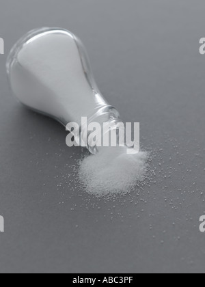 Umgestürzten Salzstreuer auf grauem Hintergrund Stockfoto