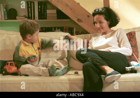 Mutter und Sohn auf dem Sofa im Wohnzimmer zusammen zu spielen Stockfoto