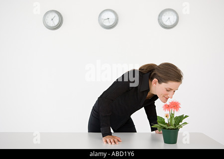 Geschäftsfrau riechen eine Blume Stockfoto