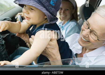 Frau halten Baby im Auto Stockfoto