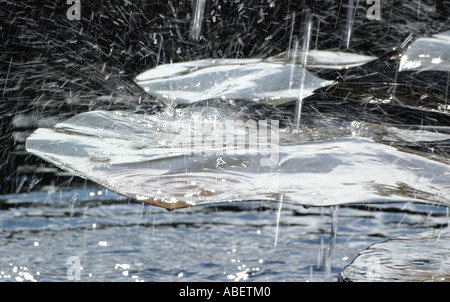 Nahaufnahme von Spritzwasser mit dynamischer Bewegung und Tropfen, die in der Luft über einem Wasserkörper schwebt Stockfoto