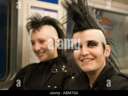 Goth Girl mit Irokesenschnitt Frisur auf London Tube mit Freund Stockfoto