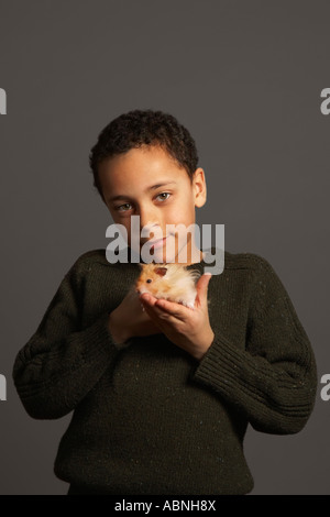 Little Boy Holding Hamster Stockfoto