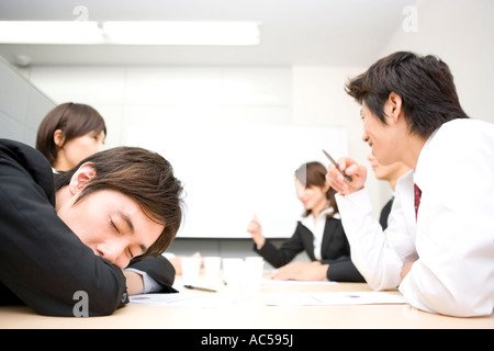 Junger Geschäftsmann schlafen während der Sitzung Stockfoto