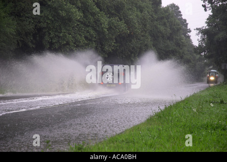 Auto fahren durch überfluteten Straße Besprühen mit Wasser nach starken Regenfällen Stockfoto