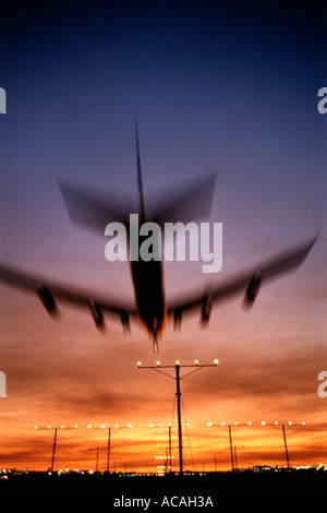 Boeing 747 Jumbo Jet landet auf dem Sonnenuntergang Sonnenaufgang Sonnenuntergang Nacht über Landebahn Landung Anflugbefeuerung Stockfoto