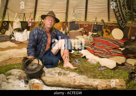 "Medizin-Brother" Phil neigt dazu, das Feuer im Inneren einer Familiengröße Tipi. Glastonbury Festival 2007, Somerset, England Stockfoto