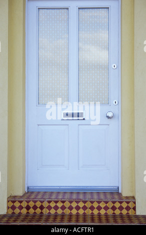 Detail der modernen Fenstermodus und getäfelten weiße Haustür blind Briefkasten Griff und Draughtproofing mit Diamant gefliest Schritte Stockfoto