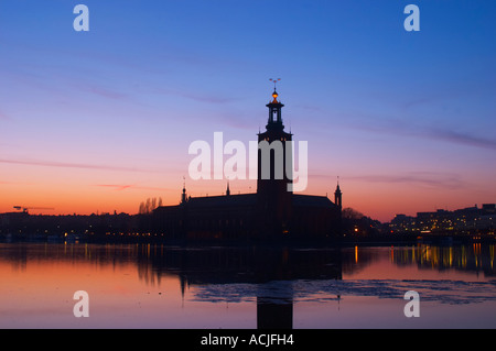 Weiten Panoramablick am Abend bei Sonnenuntergang über dem Eis bedeckt Riddarfjarden Wasser in Richtung Westen mit Kungsholmen und Stadthaus das Rathaus im Wasser gespiegelt. Iceflakes Eis Flocken Stockholm, Schweden, Sverige, Europa Stockfoto