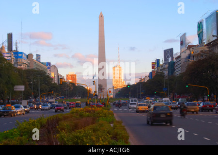 Der Obelisk, Obelisco, auf dem Plaza De La Republica Platz auf der Avenida 9 Julio Avenue des 9. Juli, Taxis und Autos im Vordergrund. Verkehr. Moderne Bürogebäude. bei Sonnenuntergang. Buenos Aires-Argentinien, Südamerika Stockfoto