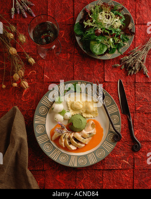 Gefülltes Brathähnchen serviert mit hausgemachten Ravioli mit pesto Stockfoto