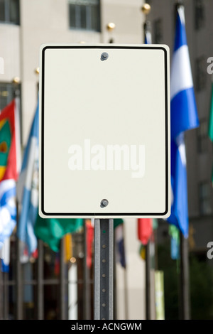 Leeres weißes Schild vor einer Gruppe von internationalen Fahnen Stockfoto