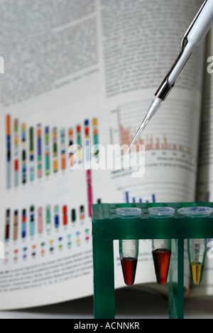 DNA-Proben in einem Reagenzglas Gestell mit Grafiken Diagramme Referenz im Hintergrund Stockfoto