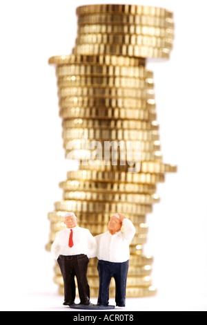 Business-Figuren und Stapel von Münzen Stockfoto