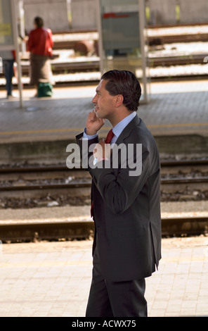 Redaktion verwenden nur kein Modell Release jungen italienischen Geschäftsmann reden über Handy auf Bahnsteig in italienischen Bahnhof Stockfoto